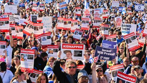 Participants hold up posters of hostages as thousands of people attend the March for Israel on the National Mall on November 14, 2023, in Washington, DC. (Photo by Noam Galai/Getty Images)