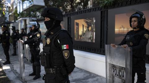 Riot police officers stand guard outside the Ecuadorian embassy in Mexico City on April 6, 2024, following the severance of diplomatic relations between the two countries. Ecuadorian authorities stormed the Mexican embassy in Quito on April 5 to arrest former vice president Jorge Glas, who had been granted political asylum there, prompting Mexico to sever diplomatic ties after the "violation of international law". (Photo by Yuri CORTEZ / AFP) (Photo by YURI CORTEZ/AFP via Getty Images)