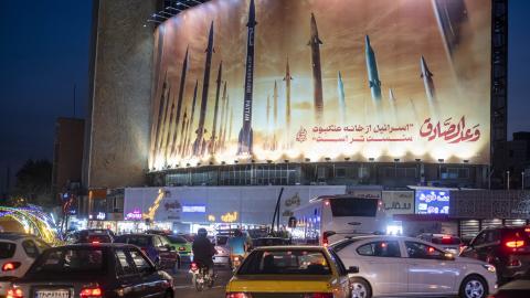 Vehicles drive under a massive billboard that is displays an illustrated image of Islamic Revolutionary Guards Corps missiles in Tehran, Iran, on April 15, 2024. (Photo by Morteza Nikoubazl/NurPhoto via Getty Images)