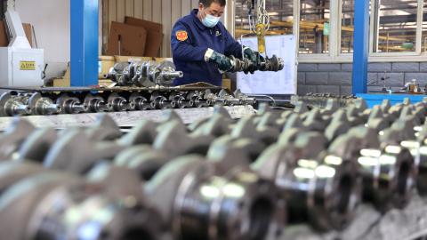 A quality inspector checks crankshafts at a factory that produces the mechanical component for the domestic market and export in Binzhou, China, on December 10, 2024. (Getty Images)