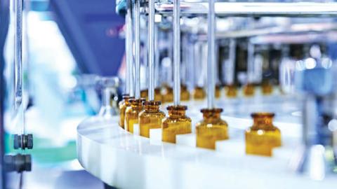 Glass medicine bottles on a production line. (Getty Images)