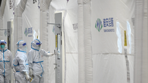 Staff members work at Dian rapid mobile diagnostics laboratory for COVID-19 testing on January 27, 2022, in Hangzhou, China. (Photo by VCG via Getty Images)
