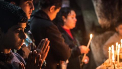 Iraqi Christians light candles inside a shrine in the grounds of Mazar Mar Eillia (Mar Elia) Catholic Church on December 12, 2014 in Erbil, Iraq. (Matt Cardy/Getty Images)