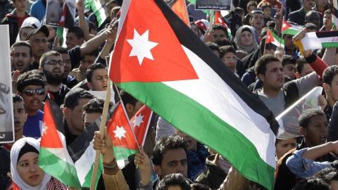 Jordanian students shout slogans and wave flags on February 5, 2015 in the capital Amman during a rally against the Islamic state (IS) group and in reaction to the burning alive of Jordanian pilot Maaz al-Kassasbeh. (KHALIL MAZRAAWI/AFP/Getty Images)