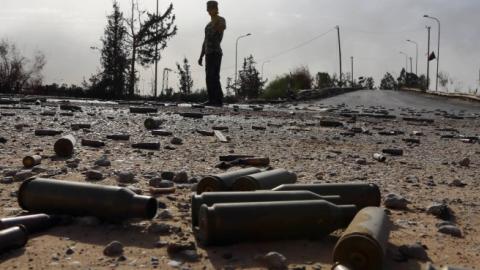 Spent bullet shells litter the ground as a member of the Islamist-linked militia of Misrata walks past following three days of battles in the area of Tripoli's International airport, on August 21, 2014. (MAHMUD TURKIA/AFP/Getty Images)