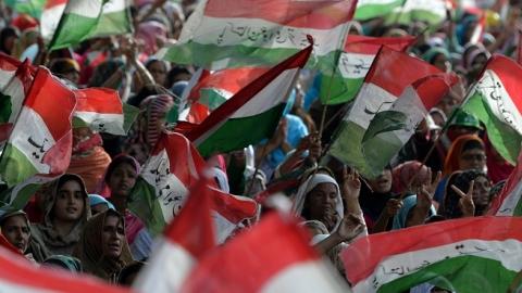 Pakistani supporters wave their party flags during a protest march in Islamabad on August 18, 2014. (AAMIR QURESHI/AFP/Getty Images)