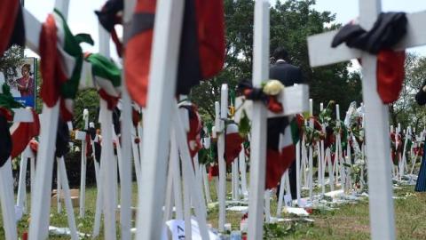 A woman looks at wooden crosses bearing names of victims at Freedom-Corner in Uhuru Park in Nairobi on April 8, 2015. (SIMON MAINA/AFP/Getty Images)