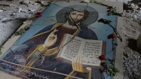 A damaged painting of Jesus Christ on the ground of Syriac Orthodox Um al-Zinar church in Homs, central Syria, May 12, 2014. (JOSEPH EID/AFP/Getty Images)