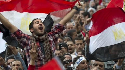 Egyptian anti-goverment demonstrators wave Egyptian flags at Cairo's Tahrir Square on February 10, 2011. (PEDRO UGARTE/AFP/Getty Images)