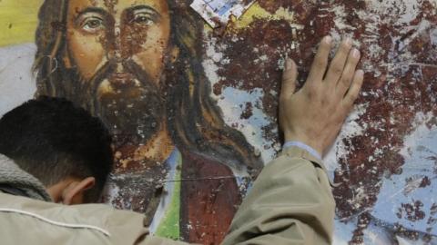 An Egyptian Christian mourns following a New Year's Eve car bomb attack on the Coptic church in Alexandria in which 21 people were killed, on January 2, 2011 outside the Al-Qiddissine (The Saints) church. (MOHAMMED ABED/AFP/Getty Images)