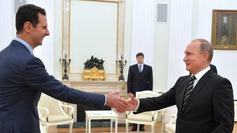 Syrian President Bashar al-Assad (L-2) meets with Russian President Vladimir Putin (R-2) at the Kremlin Palace in Moscow, Russia, on October 21, 2015. (Pool/Kremlin Press Office/Anadolu Agency/Getty Images)