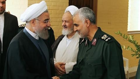 Iranian President Hassan Rouhani (L-2) shakes hands with Iranian Quds Force commander Qassem Soleimani (R-2) in Tehran, Iran on September 15, 2015. (Pool/Iranian Presidency Press Office/Anadolu Agency/Getty Images)