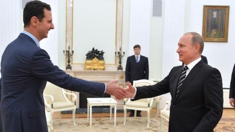 Russian President Vladimir Putin (R) greets his Syrian counterpart Bashar al-Assad (L) during a meeting at the Kremlin in Moscow on October 20, 2015. (ALEXEY DRUZHININ/AFP/Getty Images)