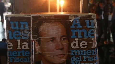 Candles burn above a poster of Albert Nisman following a 'Silent March' on February 18, 2015 in Buenos Aires, Argentina. (Mario Tama/Getty Images)