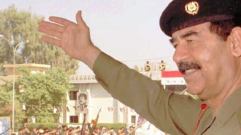  Iraqi President Saddam Hussein waves to his supporters in his first public appearance in Baghdad October 18, 1995. (INA/AFP/Getty Images)