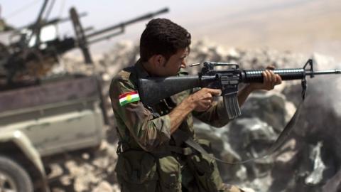 An Iraqi Kurdish Peshmerga fighter fires at Islamic-State (IS) militant positions, from his position on the top of Mount Zardak, about 25 kilometers east of Mosul on September 9, 2014. (JM LOPEZ/AFP/Getty Images)