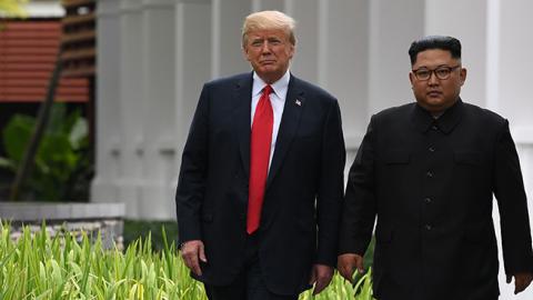North Korea's leader Kim Jong Un walks with U.S. President Donald Trump during a break in talks at their historic US-North Korea summit, at the Capella Hotel on Sentosa island in Singapore on June 12, 2018. (SAUL LOEB/AFP/Getty Images)
