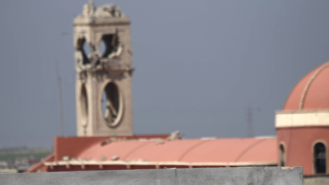 A Syriac Christian militiaman stands guard on top of a building at the Saint John's church (Mar Yohanna) in the nearly deserted predominantly Christian Iraqi town of Qaraqosh, on April 16, 2017.(CHRISTOPHE SIMON/AFP/Getty Images)