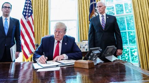US President Donald Trump signs with US Vice President Mike Pence and US Secretary of Treasury Steven Mnuchin at the White House on June 24, 2019, 'hard-hitting sanctions' on Iran's supreme leader. (MANDEL NGAN/AFP/Getty Images)
