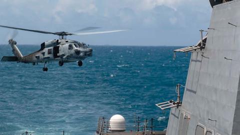 An MH-60R helicopter, assigned to Helicopter Maritime Strike Squadron 51, takes off from the flight deck as the Arleigh Burke-class guided-missile destroyer USS Mustin (DDG 89) conducts routine operations  (U.S. Navy)