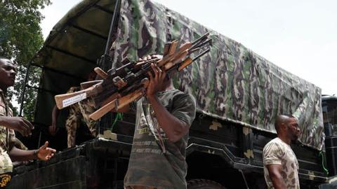 Nigerian soldiers load small arms and light weapons recovered from bandits during Operation Safe Haven on a military truck on April 21, 2022  in Plateau State in northcentral Nigeria. (Photo by Pius Utomi Ekpei/AFP via Getty Images)