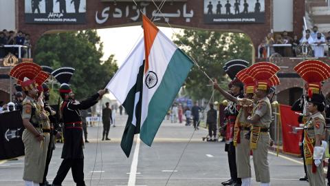 on August 1, 2022, Indian Border Security Force (BSF) soldiers (in brown) and Pakistani Rangers take part in the Beating the Retreat ceremony at the India-Pakistan Wagah border post, about 35 km from Amritsar.