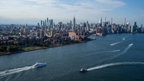 Boats move through the East River with the Manhattan skyline in the background during Labor Day Weekend in Williamsburg on September 03, 2022 in the Brooklyn Borough of New York City.