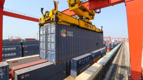 A large machine lifts containers at the China-Kazakhstan Logistics Cooperation Base in Lianyungang, China, on June 8, 2022. (CFOTO/Future Publishing via Getty Images)