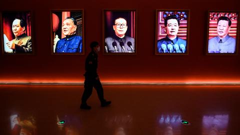 A man walks past portraits of Mao Zedong, Deng Xiaoping, Jiang Zemin, Hu Jintao, and current President Xi Jinping at Yanan Revolutionary Memorial Hallin Yanan, China, on October 15, 2022. (Jade Gao/AFP via Getty Images)