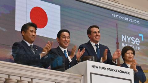 Fumio Kishida (2L), Prime Minister of Japan, stands with John Tuttle (2R), Vice Chairman of the NYSE Group before ringing in the closing bell at the New York Stock Exchange (NYSE) in New York City