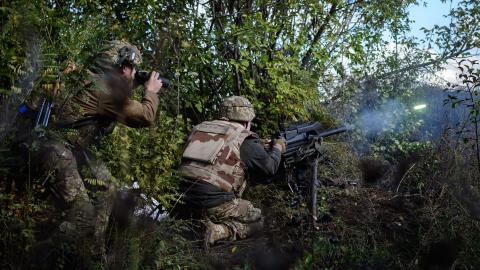 A soldier of Ukraine's 5th Regiment of Assault Infantry fires a US-made MK-19 automatic grenade launcher towards Russian positions in less than 800 metres away at a front line near Toretsk in the Donetsk region on October 12, 2022,