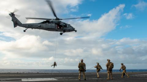 Sailors conduct helicopter rope suspension technique training from an MH-60S Sea Hawk on the flight deck aboard the USS Ronald Reagan in the Philippine Sea on October 29, 2022. (US Navy Photo by Michael B. Jarmiolowski)