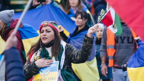An Iranian woman holds both Ukrainian and Iranian flags at a demonstration for peace in Cologne, Germany, on November 5, 2022. (Ying Tang/NurPhoto via Getty Images)