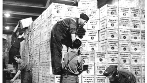 Cases of TNT and gunpowder shipped from the United States under Lend-Lease are stacked in a tunnel in western England dug out of solid rock 100 feet underground. (HUM Images/Universal Images Group via Getty Images)