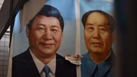 This photo taken on September 19, 2017 shows painted portraits of Chinese President Xi Jinping (L) and late communist leader Mao Zedong at a market in Beijing. As the Chinese Communist Party gathers for its most defining congress in decades, a new catchphrase is echoing through Beijing's cavernous Great Hall of the People: Xi Jinping's "new era thought". / AFP PHOTO / GREG BAKER (Photo credit should read GREG BAKER/AFP via Getty Images)