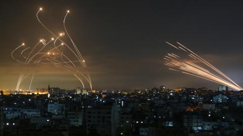 TOPSHOT - The Israeli Iron Dome missile defence system (L) intercepts rockets (R) fired by the Hamas movement towards southern Israel from Beit Lahia in the northern Gaza Strip as seen in the sky above the Gaza Strip overnight on May 14, 2021. - Israel bombarded Gaza with artillery and air strikes on Friday, May 14, in response to a new barrage of rocket fire from the Hamas-run enclave, but stopped short of a ground offensive in the conflict that has now claimed more than 100 Palestinian lives. As the viole