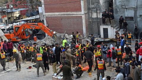 Security personnel and rescue workers prepare to search for the blast victims in the debris of a damaged mosque inside the police headquarters in Peshawar on January 30, 2023. - A blast at a mosque inside a police headquarters in Pakistan on January 30 killed at least 25 worshippers and wounded 120 more, officials said. (Photo by Abdul MAJEED / AFP) (Photo by ABDUL MAJEED/AFP via Getty Images)