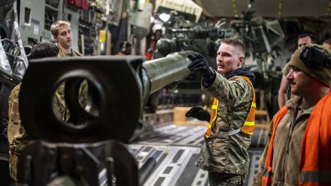 Senior Airman Trent Sloat, 435th Contingency Response Wing air transportation journeyman, directs a forklift that is off loading a M777 howitizer from a C-17 Globemaster III in Eastern Europe, May 2, 2022. The security assistance the U.S. is providing to Ukraine is enabling critical success on the battlefield against the Russian invading force. (U.S. Air Force photo by Staff Sgt. Shawn White)