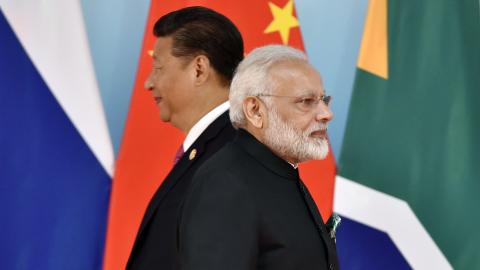 Chinese President Xi Jinping (L) and Indian Prime Minister Narendra Modi attend the group photo session during the BRICS Summit at the Xiamen International Conference and Exhibition Center in Xiamen, southeastern China's Fujian Province on September 4, 2017. Xi opened the annual summit of BRICS leaders that already has been upstaged by North Korea's latest nuclear weapons provocation. / AFP PHOTO / POOL / Kenzaburo FUKUHARA (Photo credit should read KENZABURO FUKUHARA/AFP via Getty Images)
