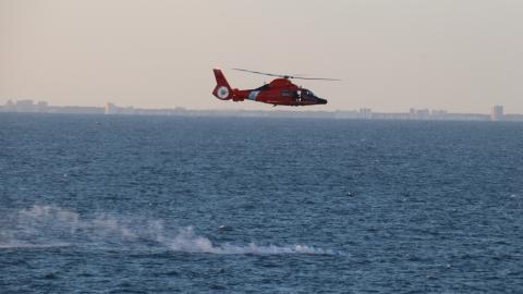 ATLANTIC OCEAN (Feb. 4, 2023) A U.S. Coast Guard helicopter flies over a debris field during recovery efforts of a high-altitude surveillance balloon. The Navy, in joint partnership with the U.S. Coast Guard, are providing multiple units in support of the effort, including ships, aircraft and an Explosive Ordnance Disposal mobile diving and salvage unit. At the direction of the President of the United States and with the full support of the Government of Canada, U.S. fighter aircraft under U.S. Northern Com