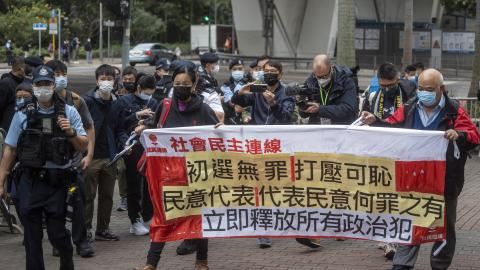 Protesters holding up a banner outside the West Kowloon Magistrates Court before the trial against 47 pro-democracy activists on February 6, 2023 in Hong Kong. (Vernon Yuen/NurPhoto via Getty Images)