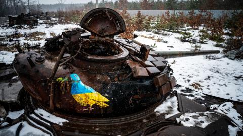 A photograph shows a street-art piece by Italian urban artist Tvboy on a destroyed Russian tank near the village of Dmytrivka, outside Kyiv, on February 1, 2023
