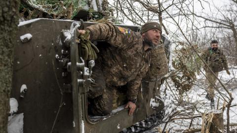 A Ukrainian army artillery crew dismounts from a self-propelled 122mm Howlitzer after firing on a Russian position on February 18, 2023 near Bakhmut, Ukraine. The army's 93rd Brigade's heavy artillery is a main element of the Ukrainian defense of the city, which is under heavy attack by Russian forces. (Photo by John Moore/Getty Images)