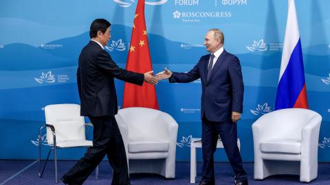 Vladimir Putin shakes hands with Chairman of the Standing Committee of the National People’s Congress of China Li Zhanshu at the Eastern Economic Forum in Primorye, Russia, on September 7, 2022, on the heels of the Vostok 2022 joint military exercises between Russia and China.