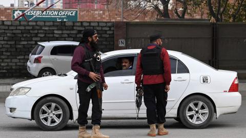 Policemen stand guard along a street in Peshawar, Pakistan, on February 1, 2023. (Farooq Naeem/AFP via Getty Images) 