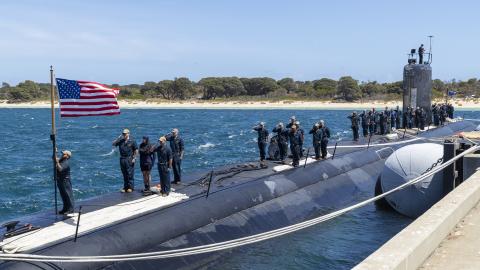 GARDEN ISLAND, Australia – Sailors assigned to the Los Angeles-class fast-attack submarine USS Asheville (SSN 758) salute the national ensign after arriving at Royal Australian Navy HMAS Stirling Naval Base, Feb. 27. Asheville is currently on patrol in support of national security interests in the U.S. 7th Fleet area of operations. (Courtesy photo by Australia Department of Defence)