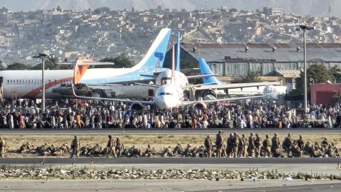 Crowds fill the tarmac while coalition forces form a security perimeter around the runway at Kabul International Airport, Afghanistan, Aug. 16, 2021. Once airborne, aircrew assigned to the U-28A Draco provided surveillance and reconnaissance of the ground situation at the airport during the U.S. withdrawal from Afghanistan. (U.S. Air Force photo courtesy of Lt. Col. Scott Hardman)