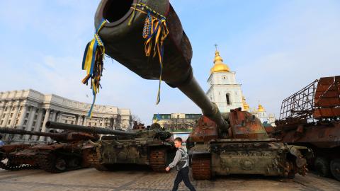 A boy walks past of a street exhibition of destroyed Russian military vehicles in center of Kyiv, Ukraine 21 March 2023. (Photo by STR/NurPhoto via Getty Images)