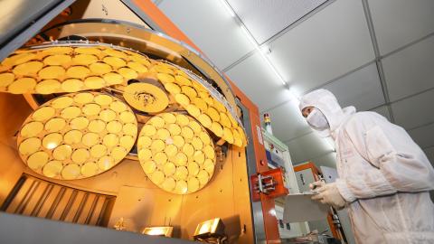 An employee works on the production line of LED epitaxial wafer on March 25, 2022, in Jiangsu Province, China. (Zhao Qirui/VCG via Getty Images)