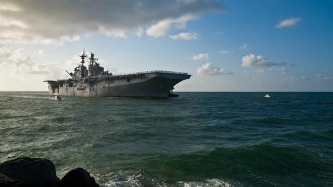 Morning sun illuminates the USS Iwo Jima (LHD-7) as she sails into Port Everglades in Fort Lauderdale, Florida. (JSABBOTT via Getty Images)